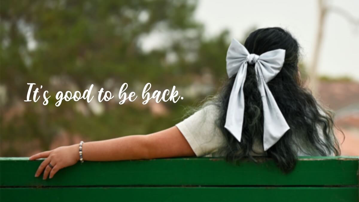 Cover image for “Overcoming the Blogging Slump” blog posts. Photo of the author from behind, sitting on a green bench, looking ahead.